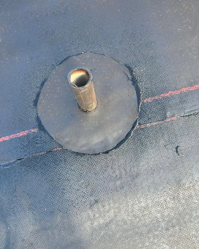 Vent pipe flashing sealed into a new flat roof membrane
