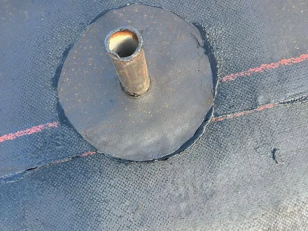 Vent pipe flashing sealed into a new flat roof membrane