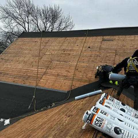 Rolls of ice and water shield membrane on old plank decking during a roof replacement