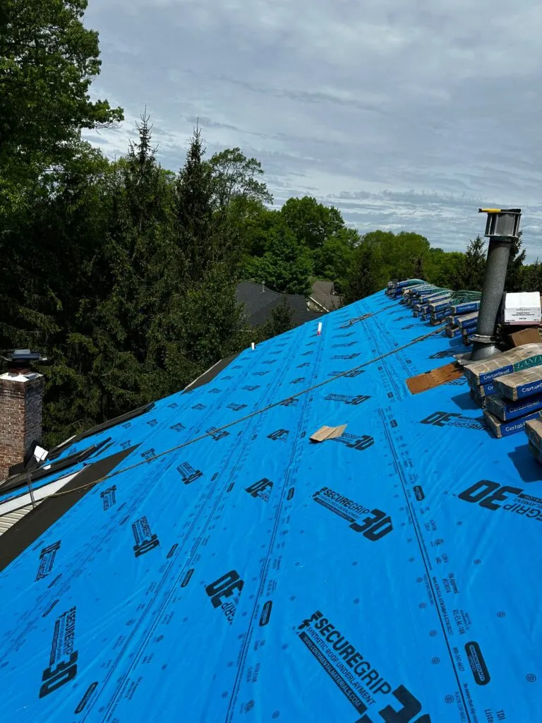 Roof leak repair in New Jersey by ALL PRO Roofing technician inspecting a residential roof